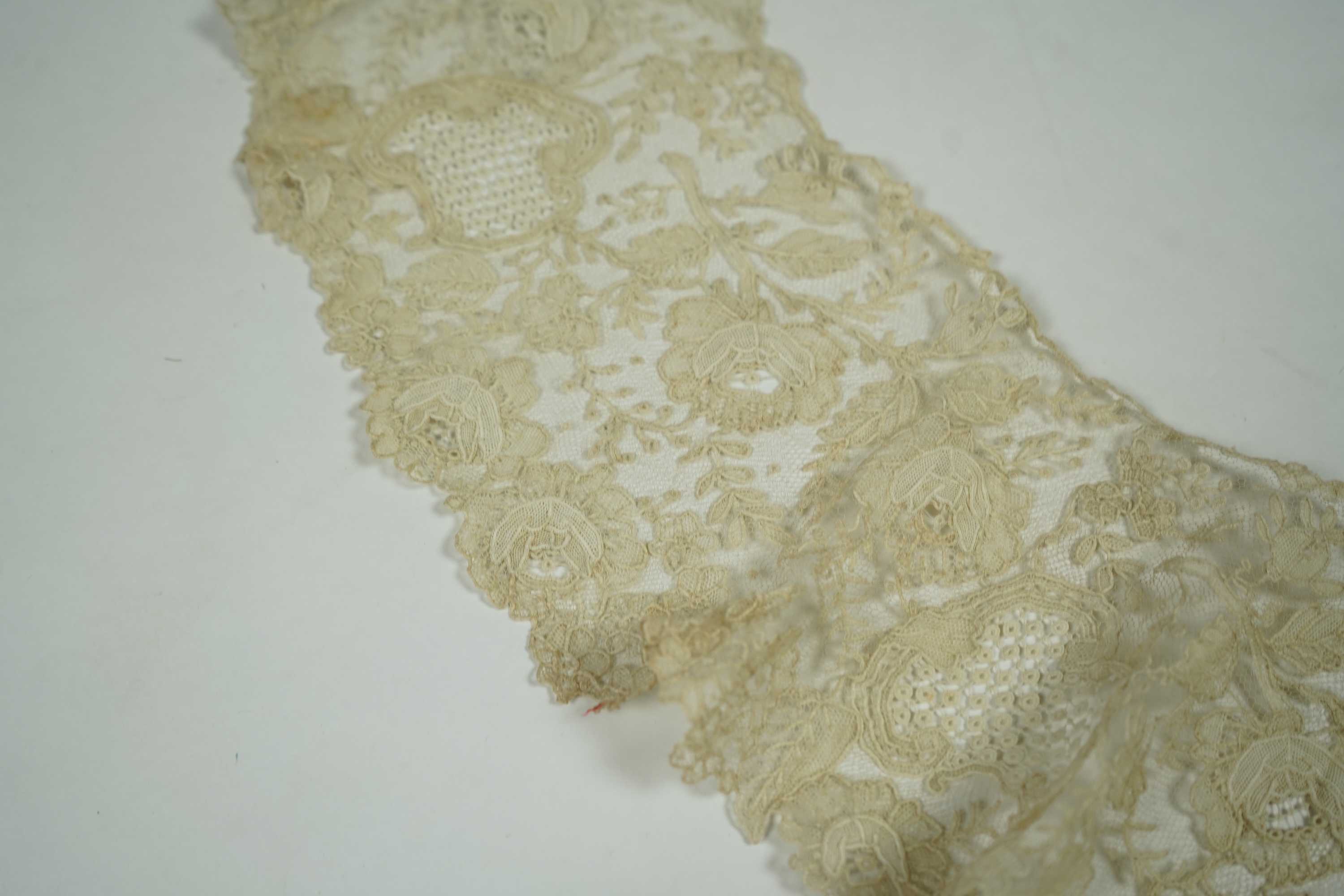 A 19th century Brussels Point de Gaz needle lace collar, lappet and wedding hankie, possibly part of a trousseau. The collar having thirty four needle lace raised flower heads within the design. The collar 100cm long x 1